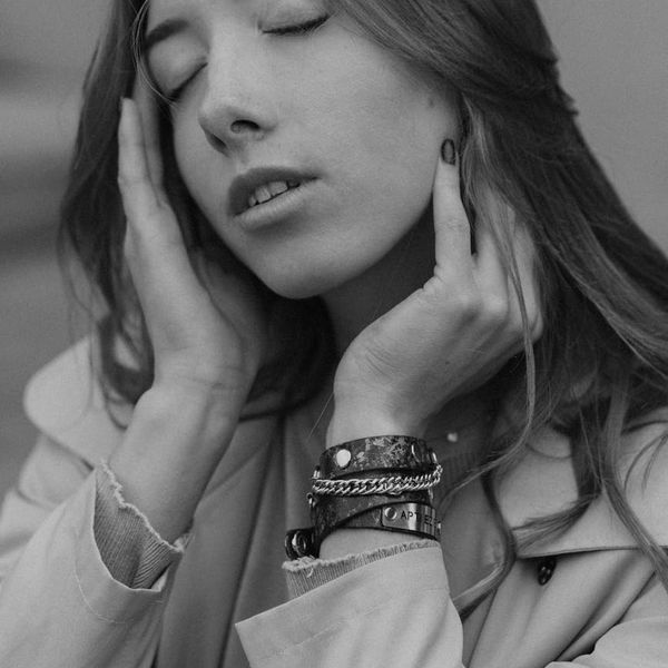 Person in a meditative pose feeling calm and balanced in a serene environment.